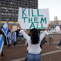 A supporter of Elor Azaria, an Israeli soldier charged with manslaughter after he shot a wounded Palestinian as he lay on the ground in Hebron, holds a placard during a protest calling for his release in Tel Aviv on April 19. (© Baz Ratner / Reuters/REUTERS)